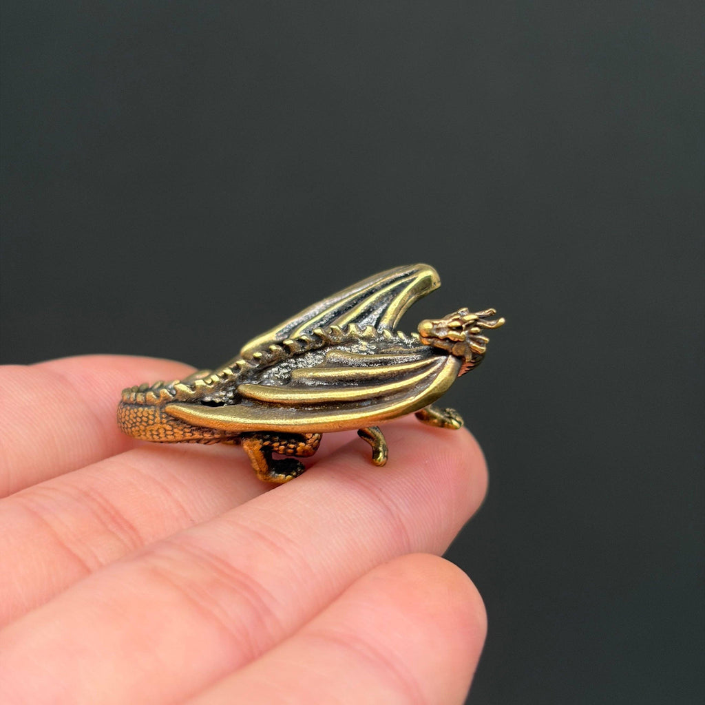 Small brass prehistoric creature figurine