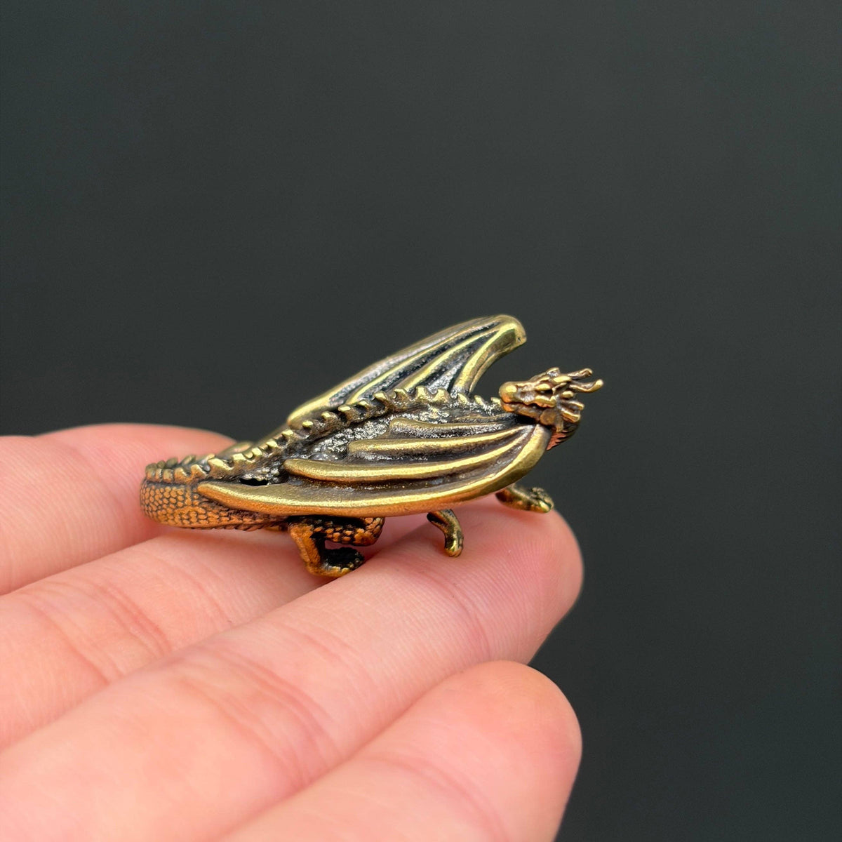 Small brass prehistoric creature figurine