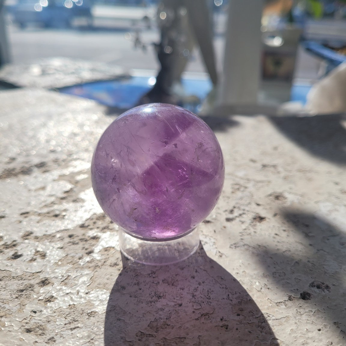 Natural 48.6mm Amethyst sphere in sunlight, exact specimen view 2