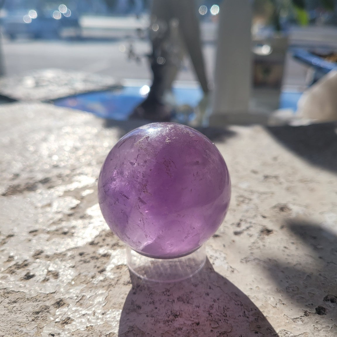 Natural 48.6mm Amethyst sphere in sunlight, exact specimen view 3