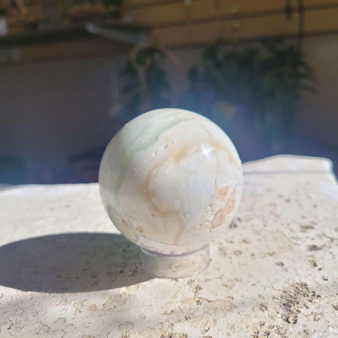 62mm Caribbean Calcite sphere pale side showing cream, soft green and natural banding