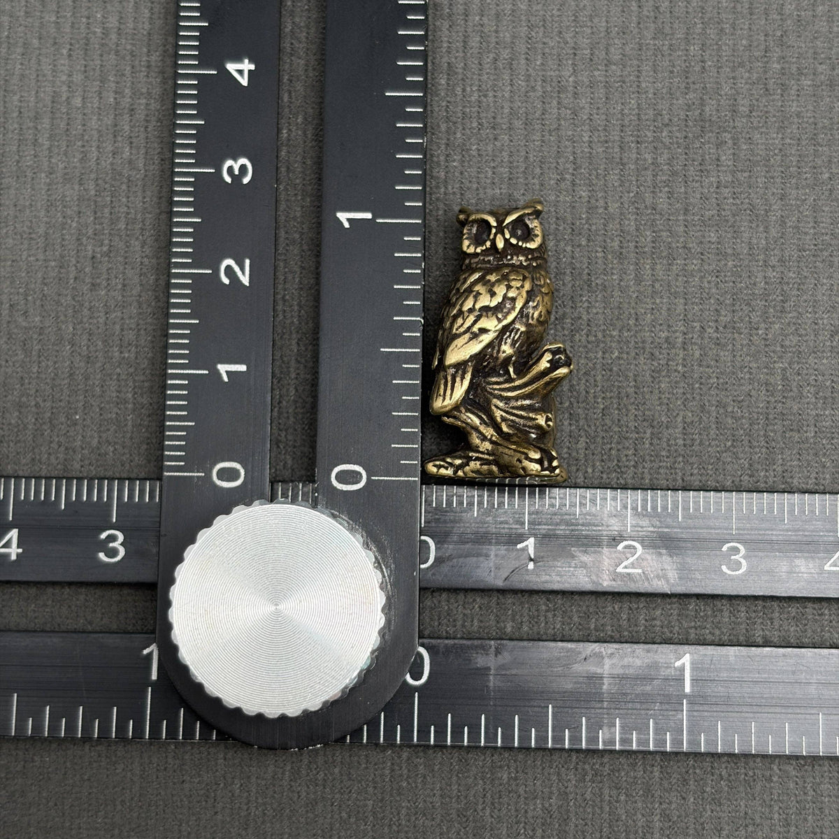 Brass owl figurine perched on a branch