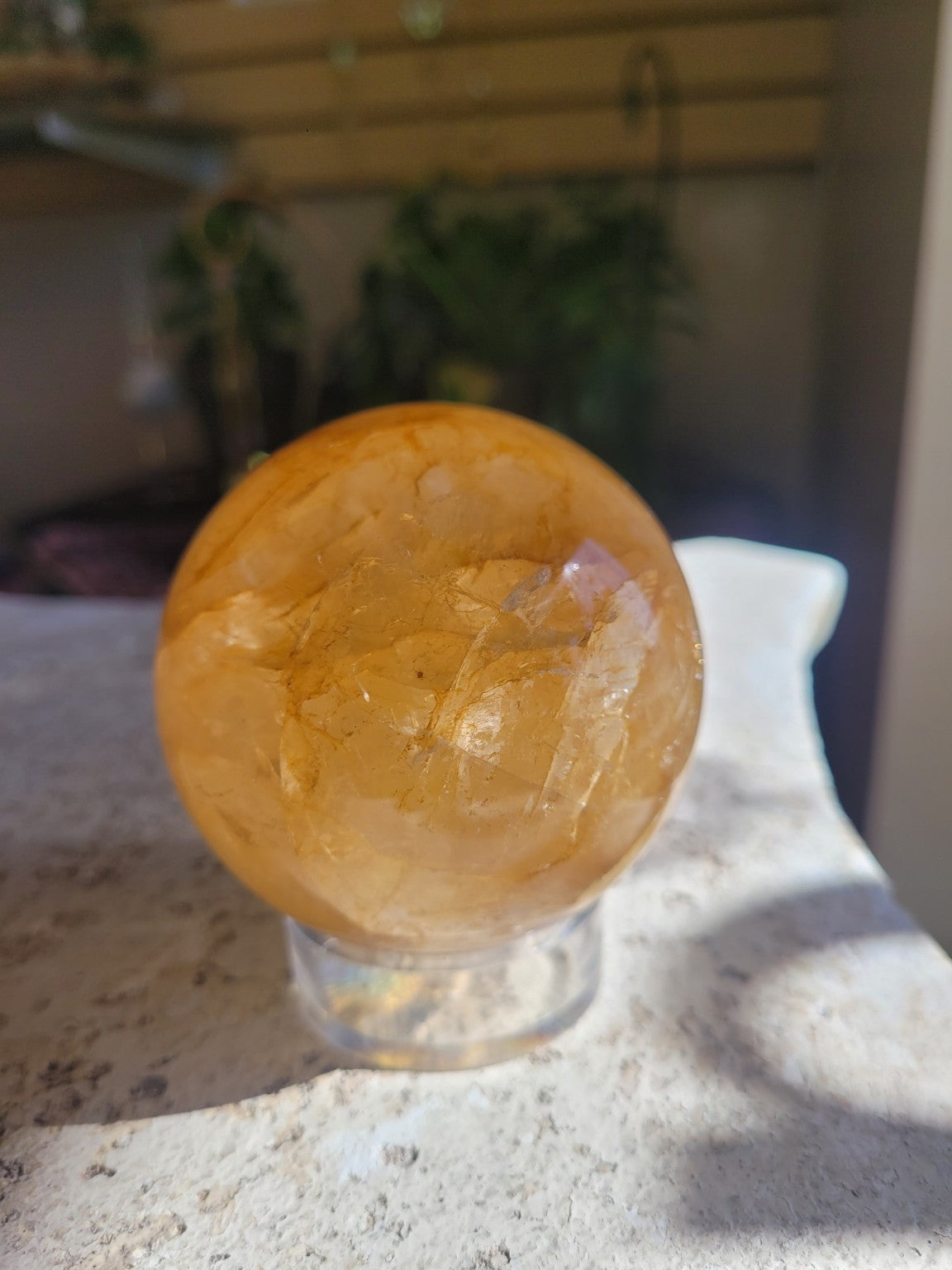 Natural Golden Healer Quartz sphere in softer light showing its warm golden everyday appearance